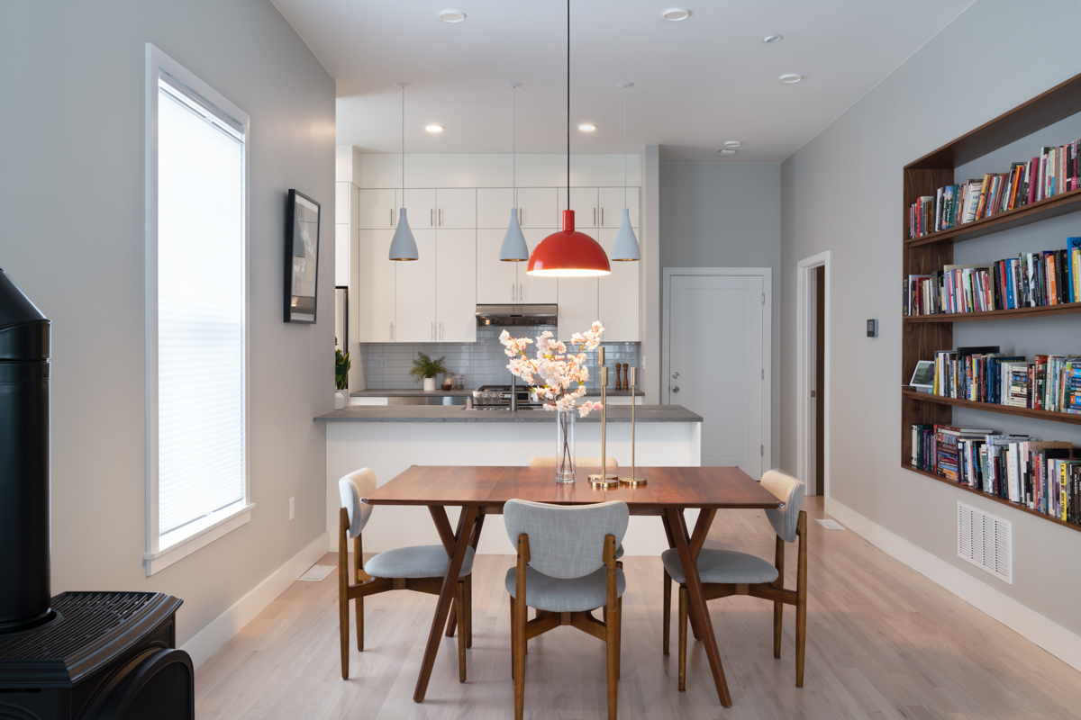 kitchen and dining area with red and gray light fixtures